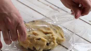 wrapping chocolate chip cookie dough with plastic wrap