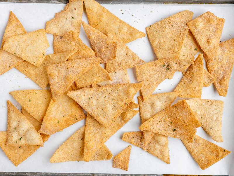 a baking tray with a bunch of fresh chips scattered around