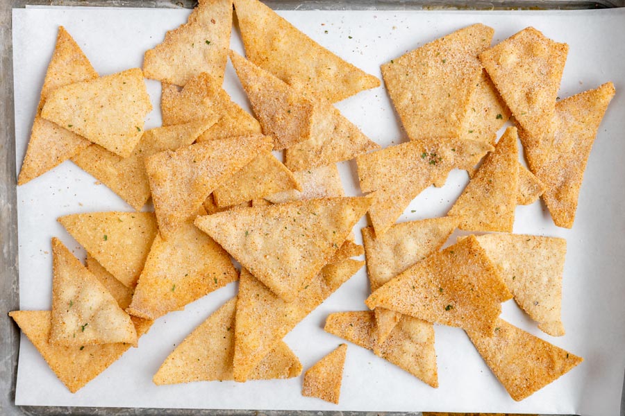 a baking tray with a bunch of fresh chips scattered around