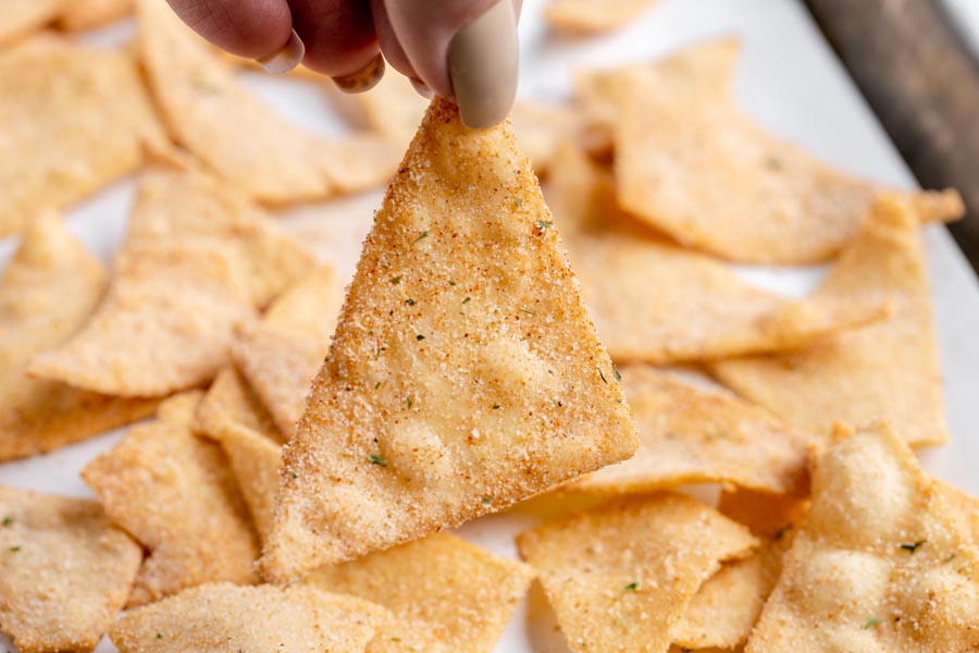 holding a doritos chip in front of other chips