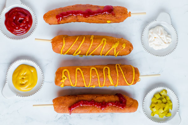 Corn dogs with ketchup, mustard, relish & mayo