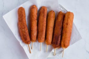 6 keto corn dogs sitting in a bowl and ready to eat