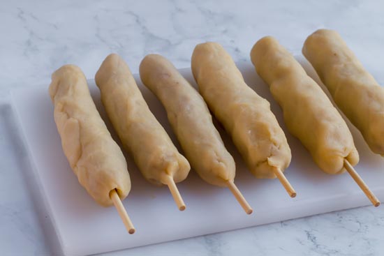 keto corn dogs before frying with breading on them