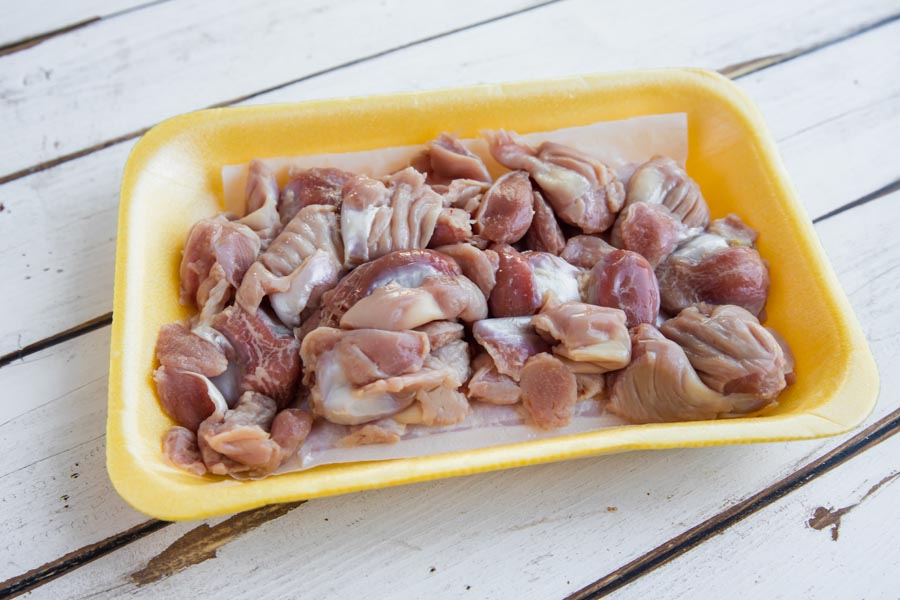 raw chicken gizzards in a container