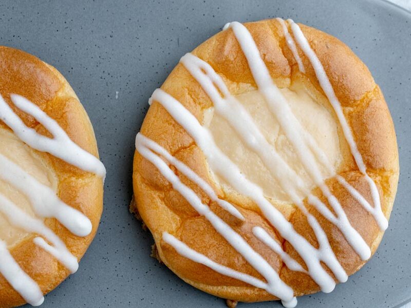 looking down onto a cream cheese danish with stripes of white icing