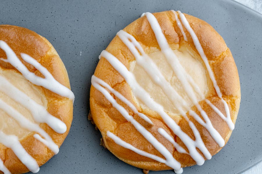 looking down onto a cream cheese danish with stripes of white icing