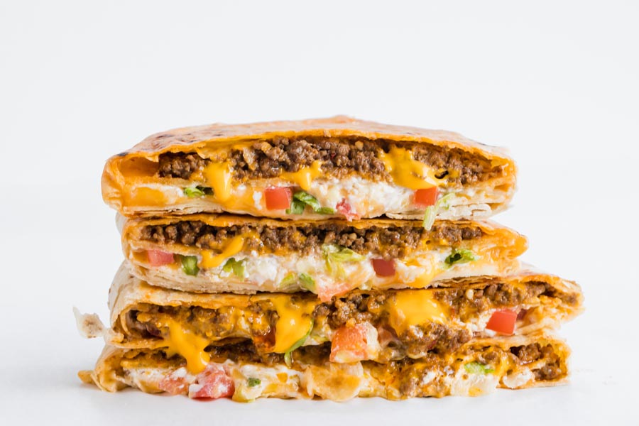 four cheesy keto crunchwrap stacked on top of each other