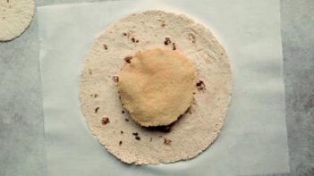 a tostada shell in the center of a large tortilla