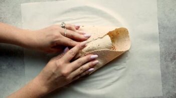 folding the tortilla of a crunch wrap