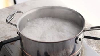 coconut nut milk boiling over a burner