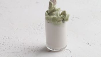 layering green tea matcha foam on milk