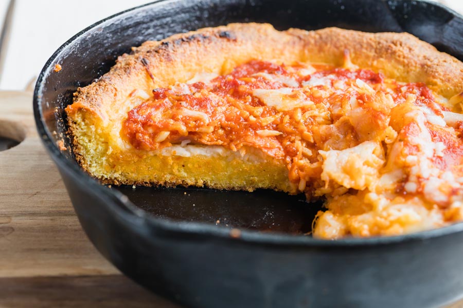 deep dish pizza in a black skillet