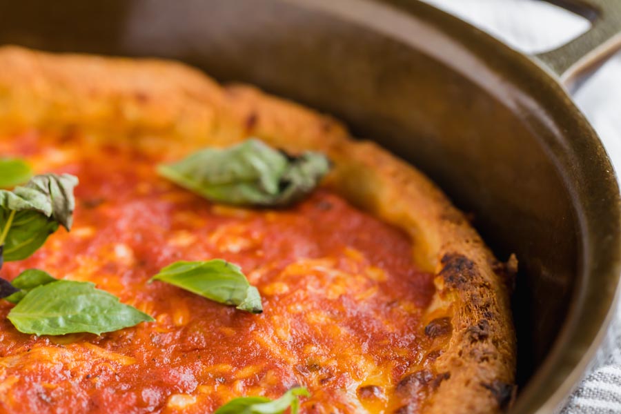 crispy pizza crust with a tomato cheese sauce