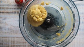 keto pizza dough balled up in a food processor