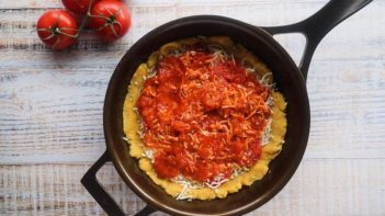 unbaked pizza in a cast iron skillet