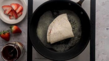 frying tortilla wrap in butter in a non-stick skillet