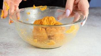 holding a bowl with tortilla dough inside