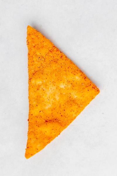 an orange nacho chip on a white background