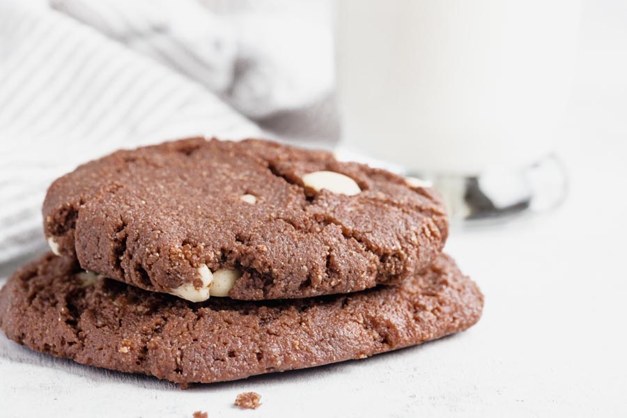 two cookies on top of each other with a glass of milk