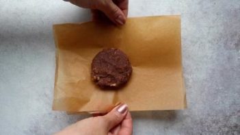 an unbaked double chocolate cookie on parchment paper