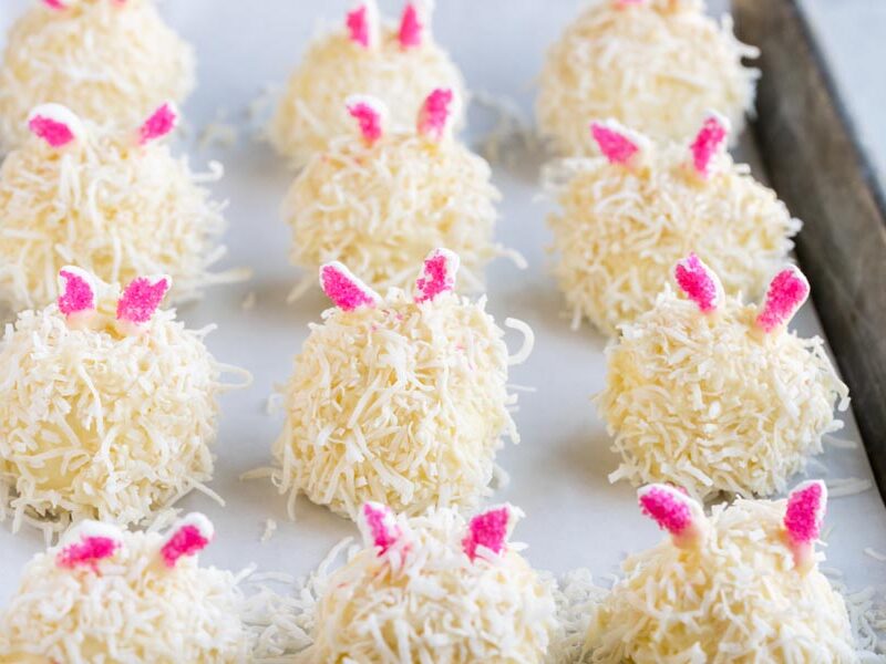 white cheesecake bunnies with shredded coconut and pink marshmallow ears in a row