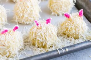 three little bunnies with pink ears and shredded coconut on them