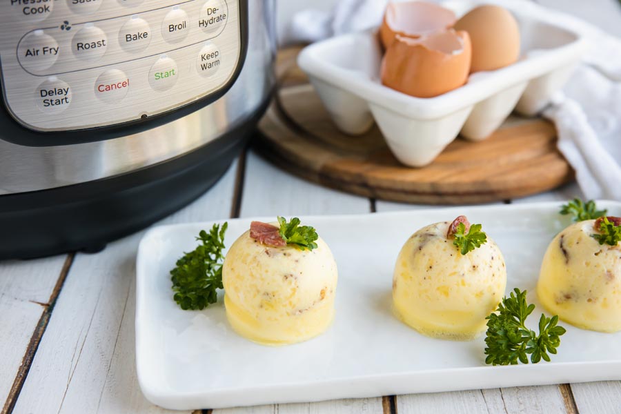 egg bites on a plate in front of an instant pot