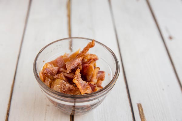 cooked crumbled bacon in a small glass bowl