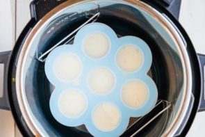 blue silicone egg mold sitting inside a pressure cooker