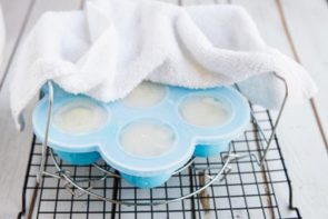 trivet and egg mold sitting on a white board with a white linen