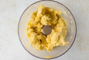 Keto pie crust dough blended in a food processor until a smooth, crumbly dough forms.