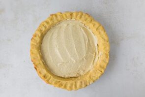 Eggnog filling spread evenly into the prepared keto pie crust.