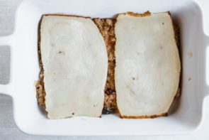 two sliced chicken deli meat slices on a casserole dish