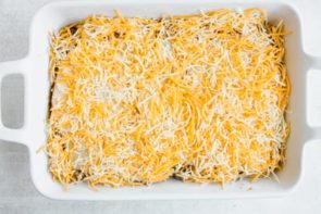 shredded cheese on top of a casserole