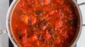 keto enchilada sauce of tomatoes and chiles cooking in a skillet