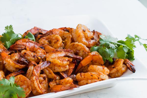 firecrack shrimp laid out in a white dish