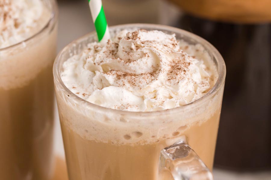 whipped cream on a coffee frappuccino and cocoa dusted on top