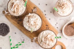 four frappuccinos with three on a wooden board