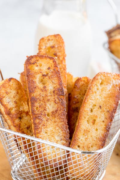 a basket with 7 pieces of french toast bites inside
