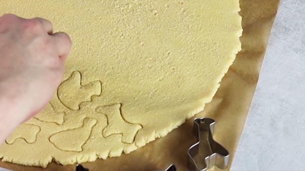 cutting out animal shapes in the keto cookie dough
