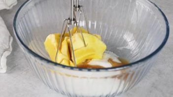 mixing butter and sweetener together in a bowl with an electric mixer