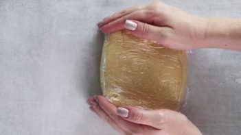 molding keto animal cookie dough in plastic wrap