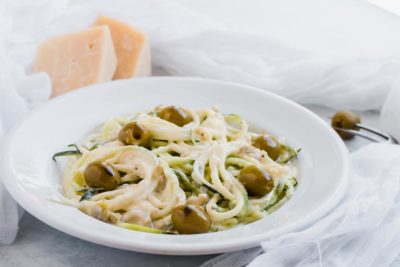 plate of creamy garlic and olive alfredo with zoodles