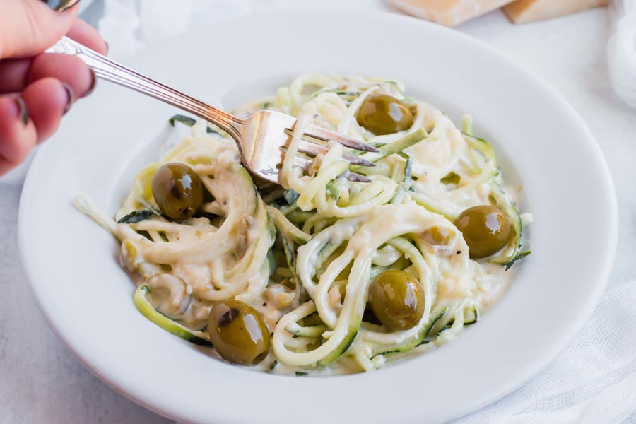 forkful of zoodles with keto alfredo sauce