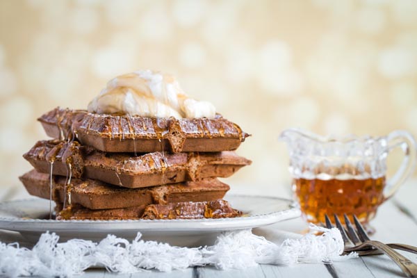 syrup dripping down a stack of gingerbread waffles