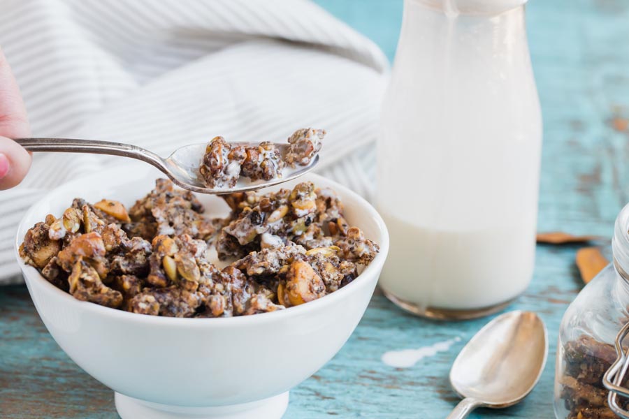scooping out a spoonful of keto granola cereal