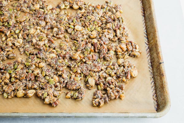 granola spread out on a baking tray in a thin layer