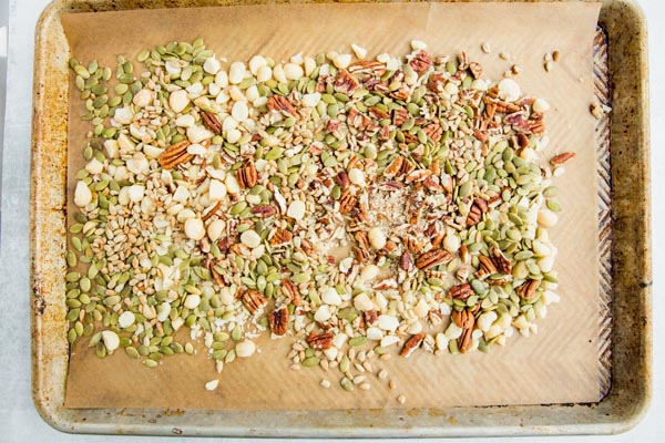 nuts and seeds spread out on a baking tray