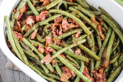 close up of crispy keto green beans with bacon sprinkled on top
