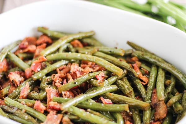 a casserole dish filled with crispy green beans and bacon